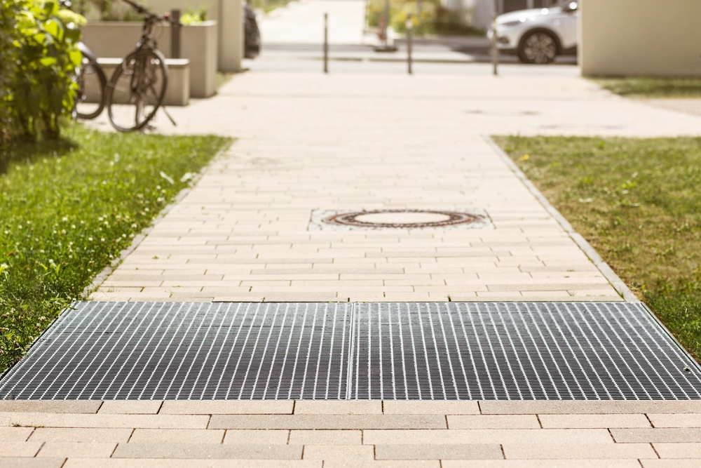 How can hardscape design support better drainage in the yard